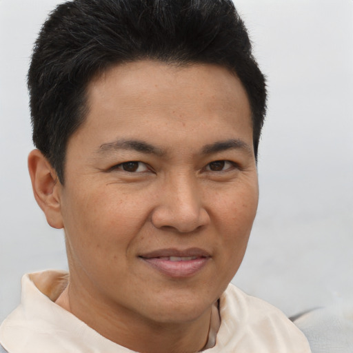 Joyful asian young-adult male with short  brown hair and brown eyes