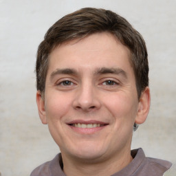 Joyful white young-adult male with short  brown hair and brown eyes