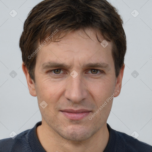 Joyful white adult male with short  brown hair and brown eyes