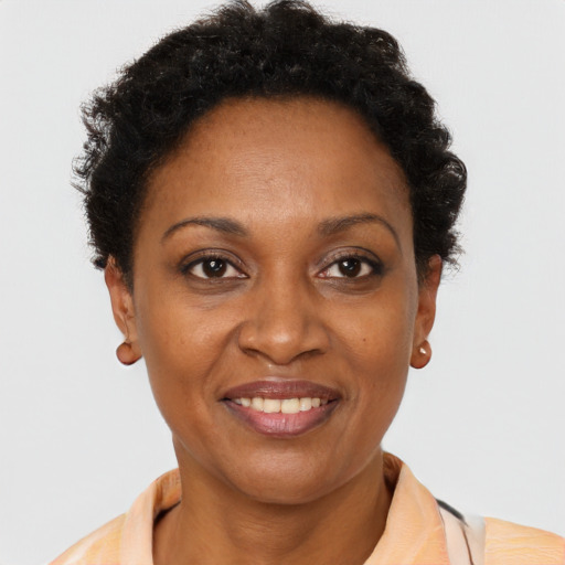 Joyful black adult female with short  brown hair and brown eyes