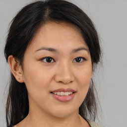 Joyful asian young-adult female with medium  brown hair and brown eyes