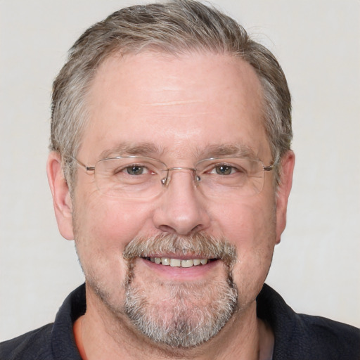 Joyful white middle-aged male with short  gray hair and grey eyes