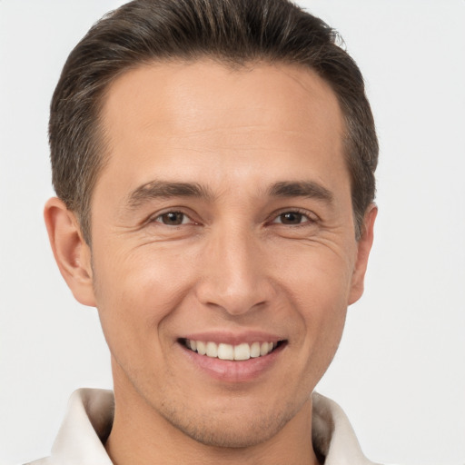 Joyful white adult male with short  brown hair and brown eyes