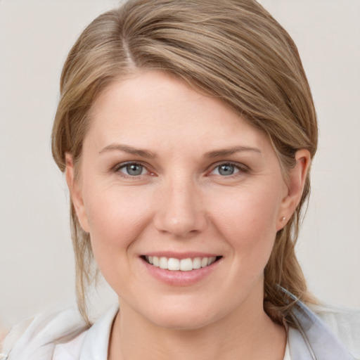 Joyful white young-adult female with medium  brown hair and grey eyes