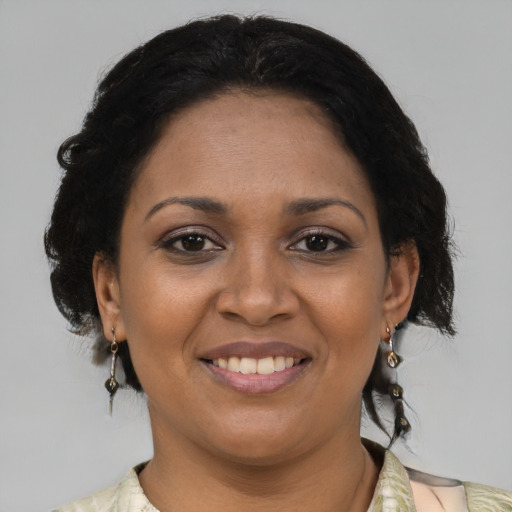 Joyful black adult female with medium  black hair and brown eyes