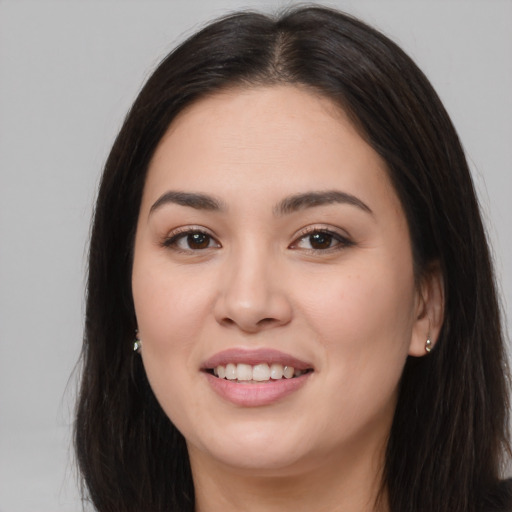 Joyful asian young-adult female with long  brown hair and brown eyes