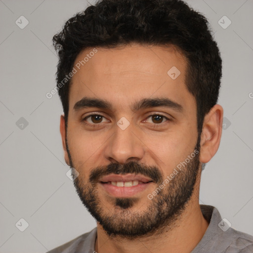 Joyful white young-adult male with short  black hair and brown eyes