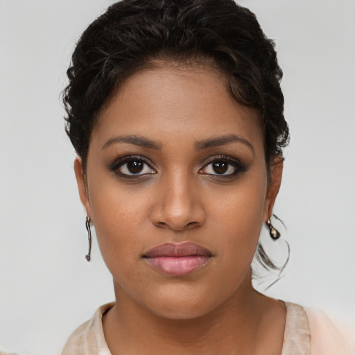 Joyful latino young-adult female with short  brown hair and brown eyes