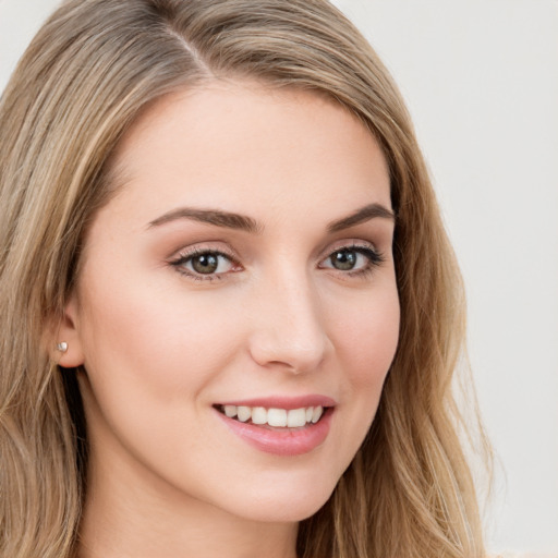 Joyful white young-adult female with long  brown hair and green eyes