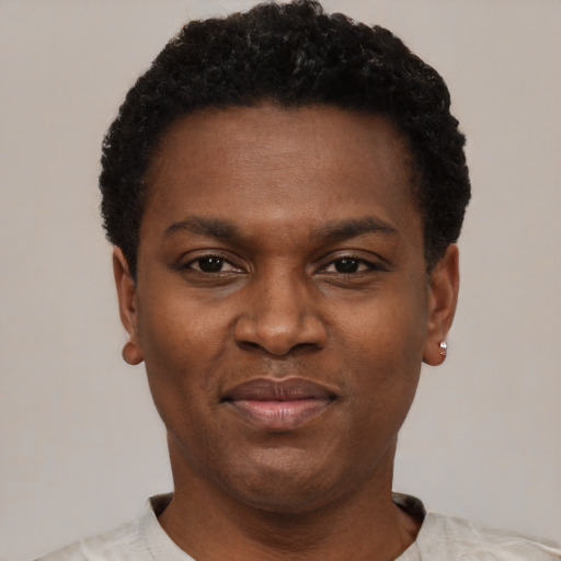 Joyful black young-adult male with short  black hair and brown eyes