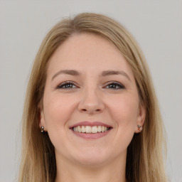 Joyful white young-adult female with long  brown hair and grey eyes