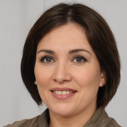 Joyful white adult female with medium  brown hair and brown eyes