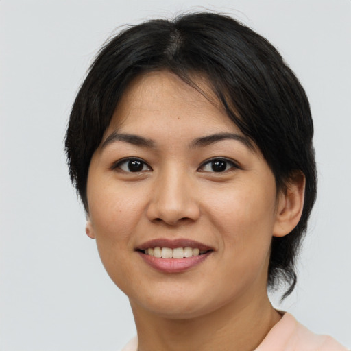 Joyful asian young-adult female with short  black hair and brown eyes