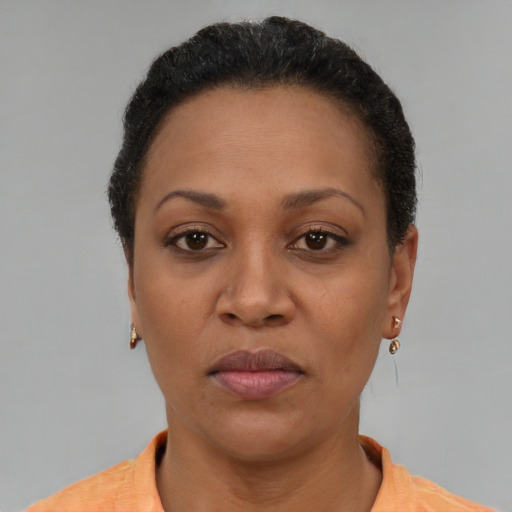 Joyful black adult female with short  brown hair and brown eyes