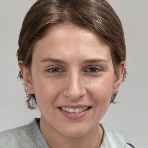 Joyful white young-adult female with medium  brown hair and grey eyes