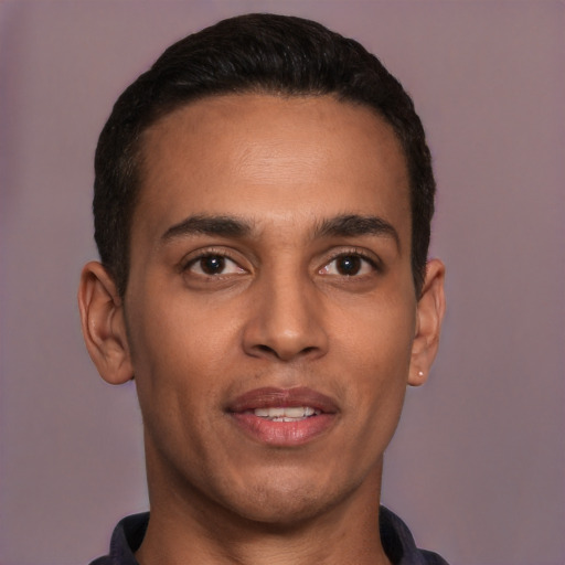 Joyful white young-adult male with short  black hair and brown eyes