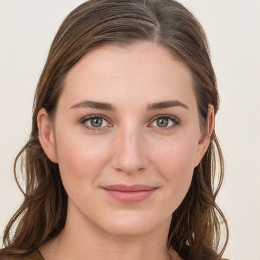 Joyful white young-adult female with long  brown hair and grey eyes