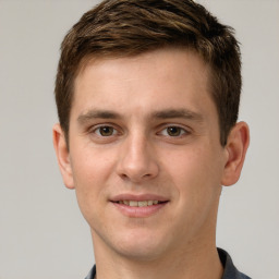 Joyful white young-adult male with short  brown hair and grey eyes