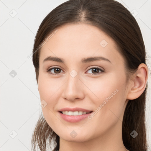 Joyful white young-adult female with long  brown hair and brown eyes