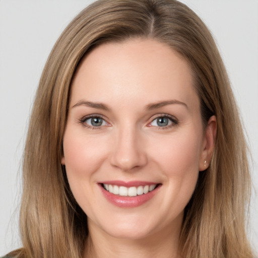 Joyful white young-adult female with long  brown hair and grey eyes