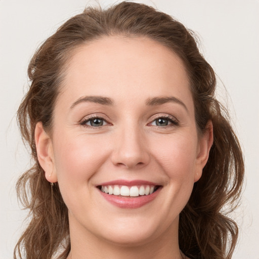 Joyful white young-adult female with long  brown hair and grey eyes