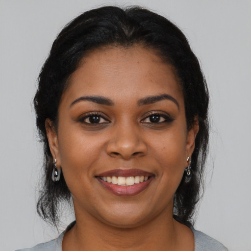 Joyful latino young-adult female with medium  black hair and brown eyes