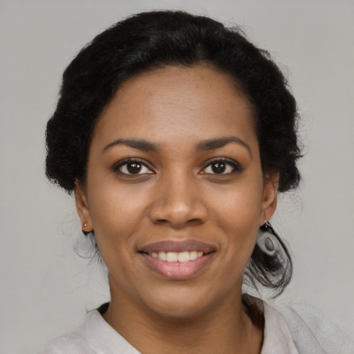 Joyful black young-adult female with medium  black hair and brown eyes