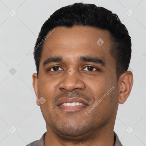 Joyful latino young-adult male with short  black hair and brown eyes