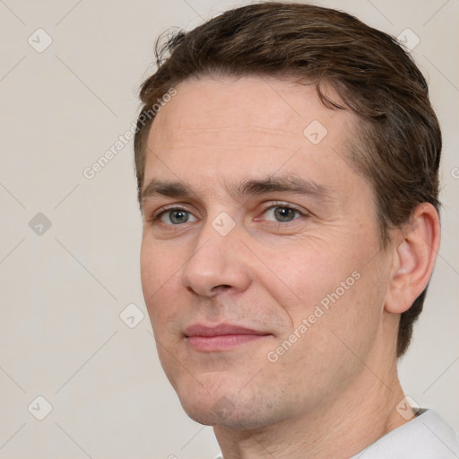 Joyful white adult male with short  brown hair and brown eyes