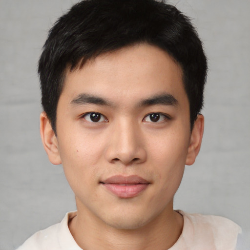 Joyful asian young-adult male with short  black hair and brown eyes