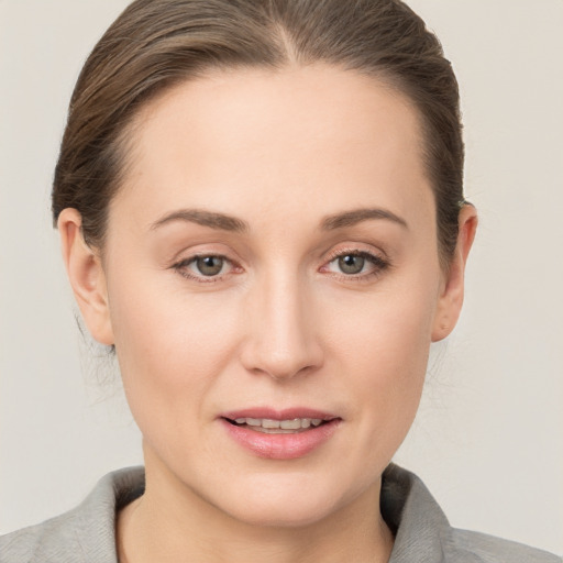 Joyful white young-adult female with short  brown hair and grey eyes