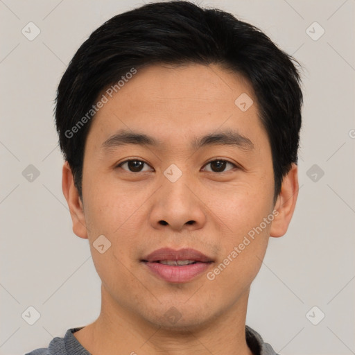 Joyful asian young-adult male with short  black hair and brown eyes