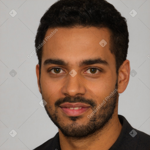 Joyful latino young-adult male with short  black hair and brown eyes