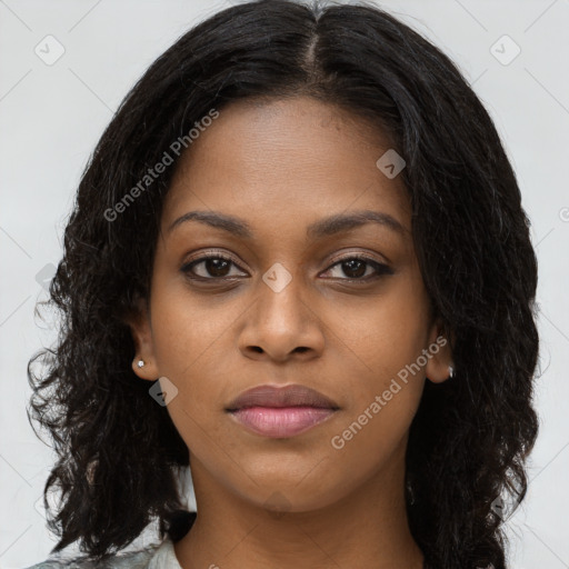 Joyful black young-adult female with long  black hair and brown eyes