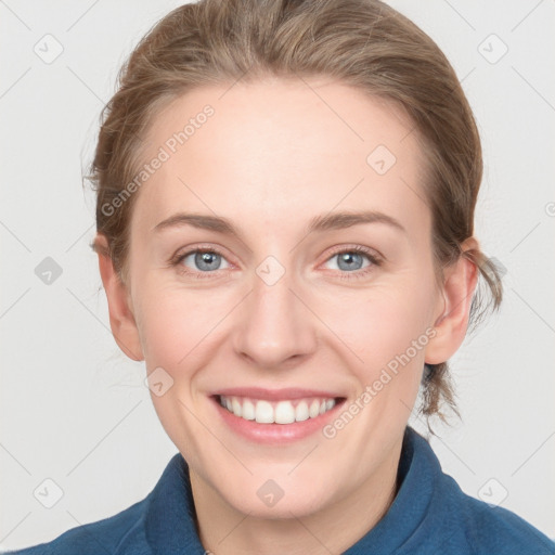 Joyful white young-adult female with medium  brown hair and blue eyes