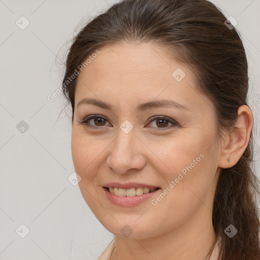 Joyful white young-adult female with long  brown hair and brown eyes