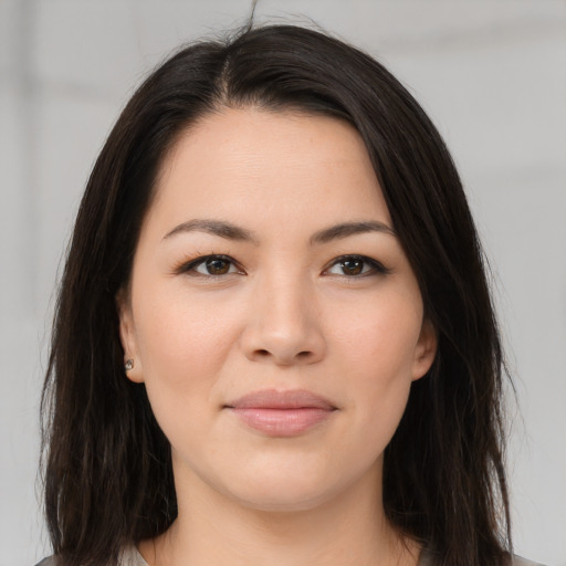 Joyful asian young-adult female with long  brown hair and brown eyes
