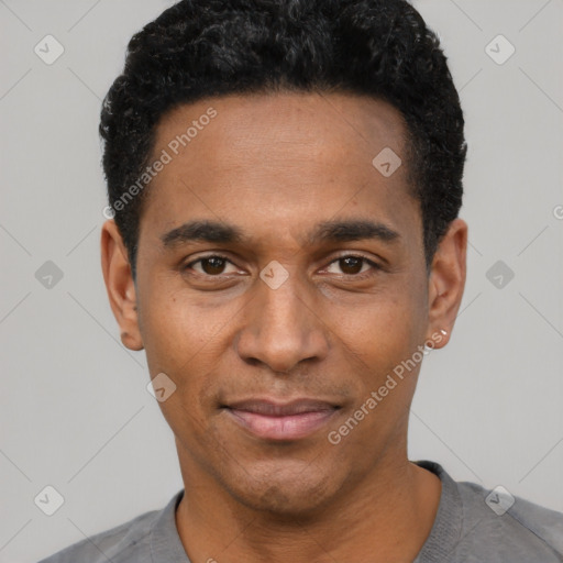 Joyful black adult male with short  black hair and brown eyes
