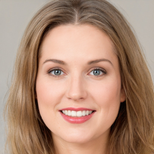 Joyful white young-adult female with long  brown hair and green eyes