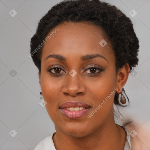 Joyful black young-adult female with short  black hair and brown eyes