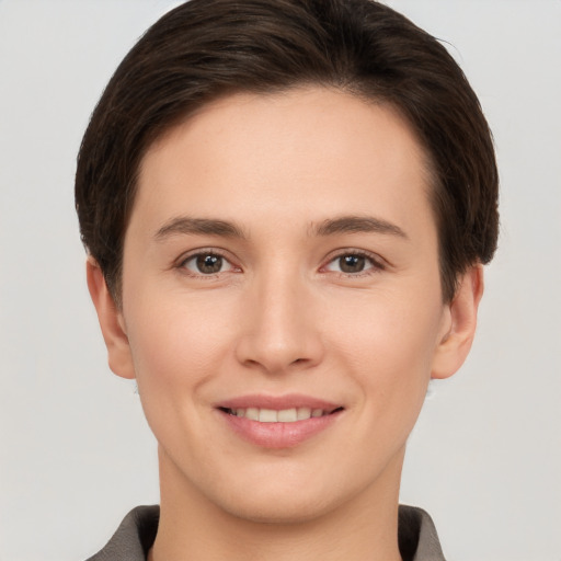 Joyful white young-adult female with short  brown hair and brown eyes