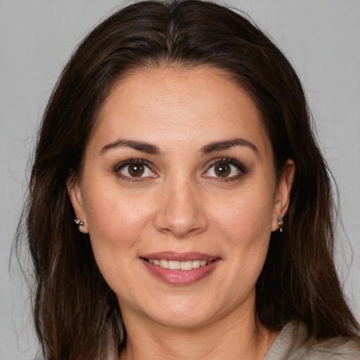 Joyful white adult female with medium  brown hair and brown eyes