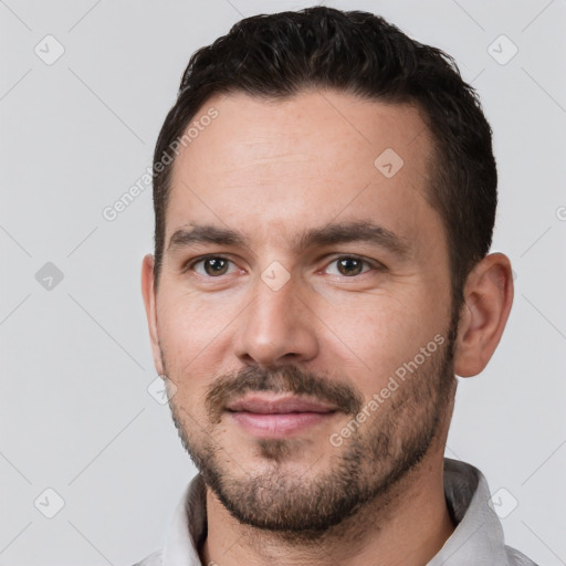 Joyful white young-adult male with short  black hair and brown eyes