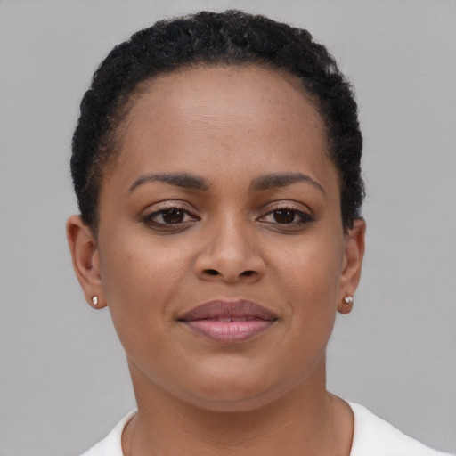 Joyful black young-adult female with short  brown hair and brown eyes