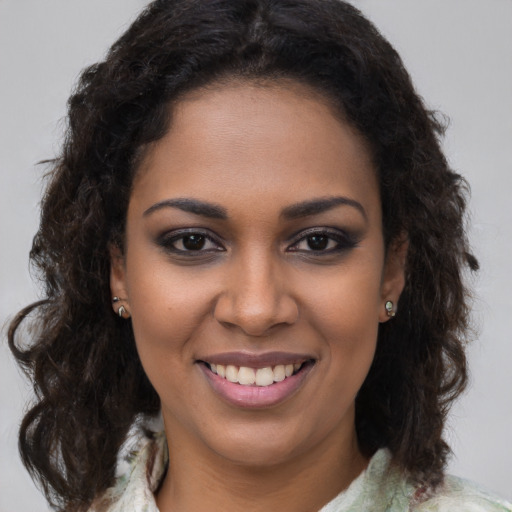 Joyful black young-adult female with medium  brown hair and brown eyes