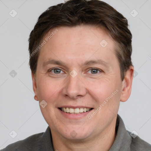 Joyful white adult male with short  brown hair and grey eyes