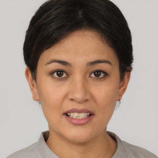 Joyful asian young-adult female with short  brown hair and brown eyes