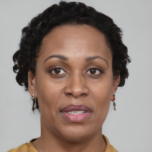 Joyful black adult female with short  brown hair and brown eyes