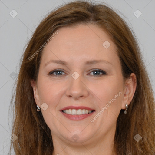 Joyful white adult female with long  brown hair and grey eyes