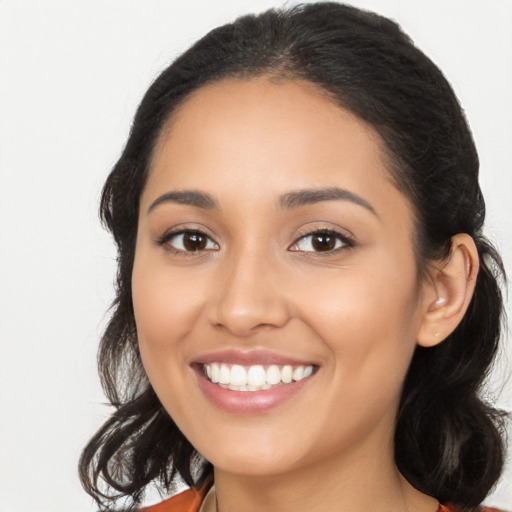 Joyful latino young-adult female with long  black hair and brown eyes